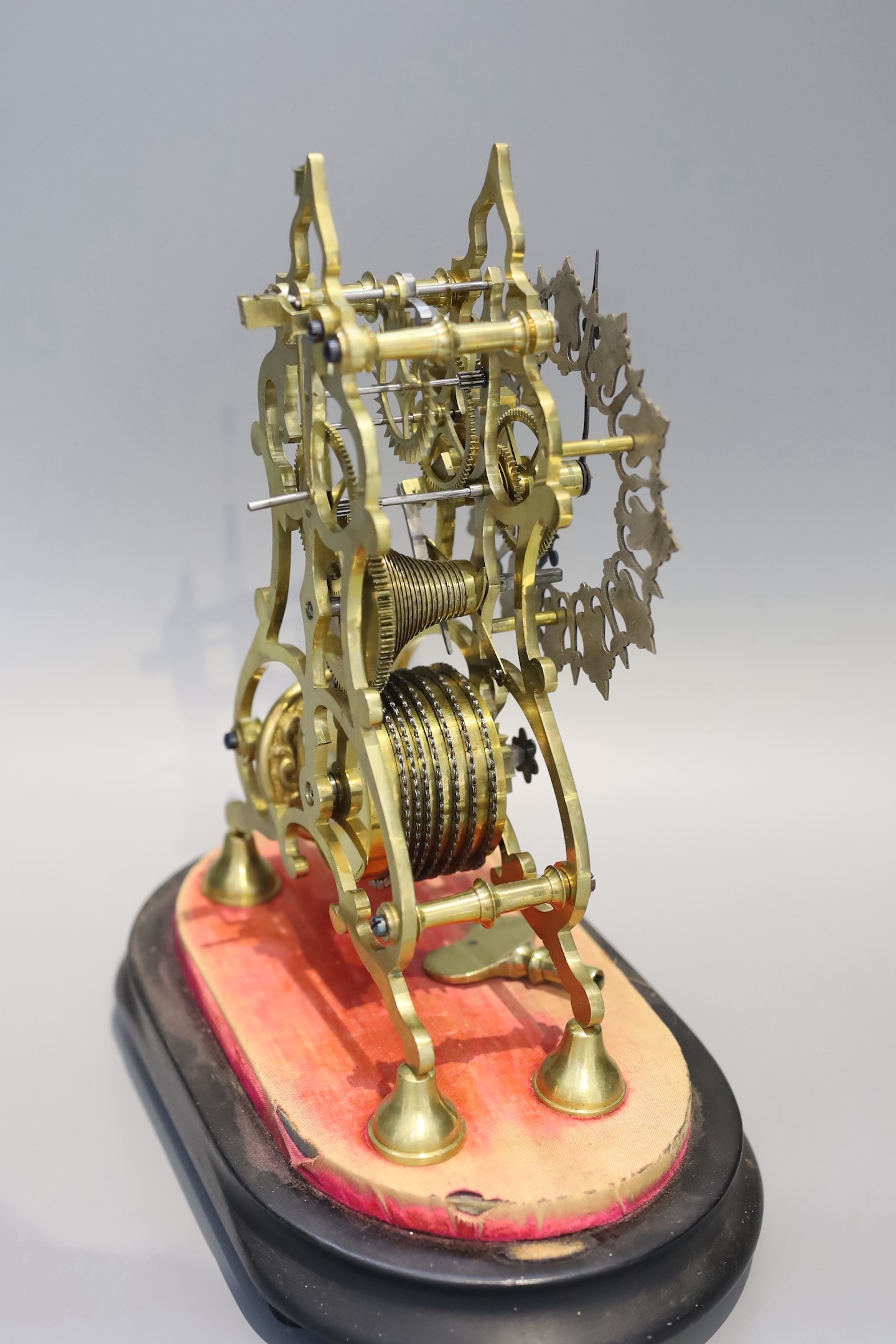 A 19th century brass skeleton mantel timepiece, under glass dome, with single fusee movement and pierced silvered chapter ring, height 24cm